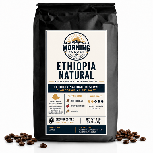 A 1 lb bag of The Morning Club Ethiopia Natural single-origin light roast coffee displayed on a white background with scattered coffee beans.