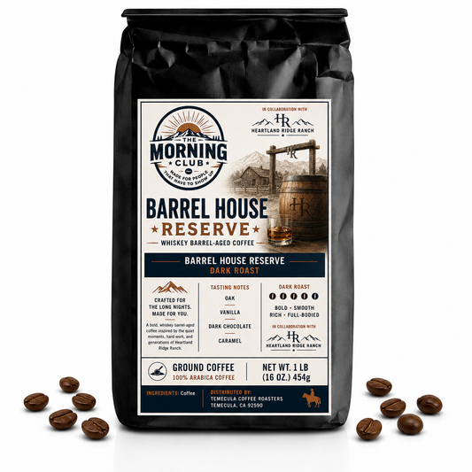 1 lb bag of Morning Club Barrel House Reserve dark roast whiskey barrel-aged coffee on a white background with scattered coffee beans.