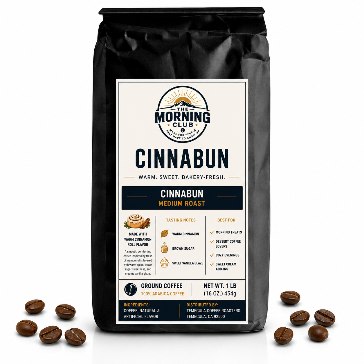 1 lb bag of Morning Club Cinnabun flavored ground coffee on a white background with coffee beans scattered around the base