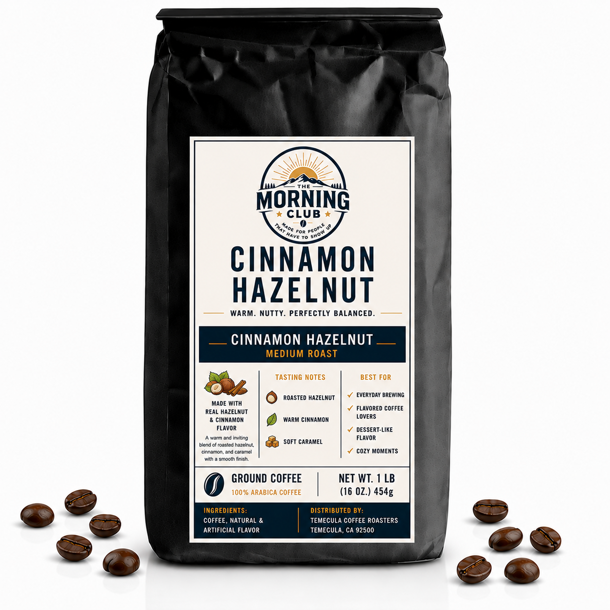 1 lb bag of Morning Club Cinnamon Hazelnut flavored ground coffee on a white background with coffee beans scattered around the base