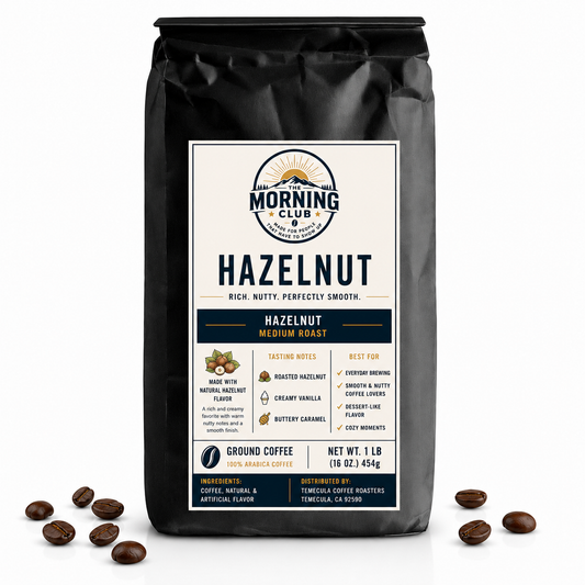 1 lb bag of Morning Club Hazelnut flavored coffee, medium roast ground coffee with roasted hazelnut notes on a white background with scattered coffee beans.